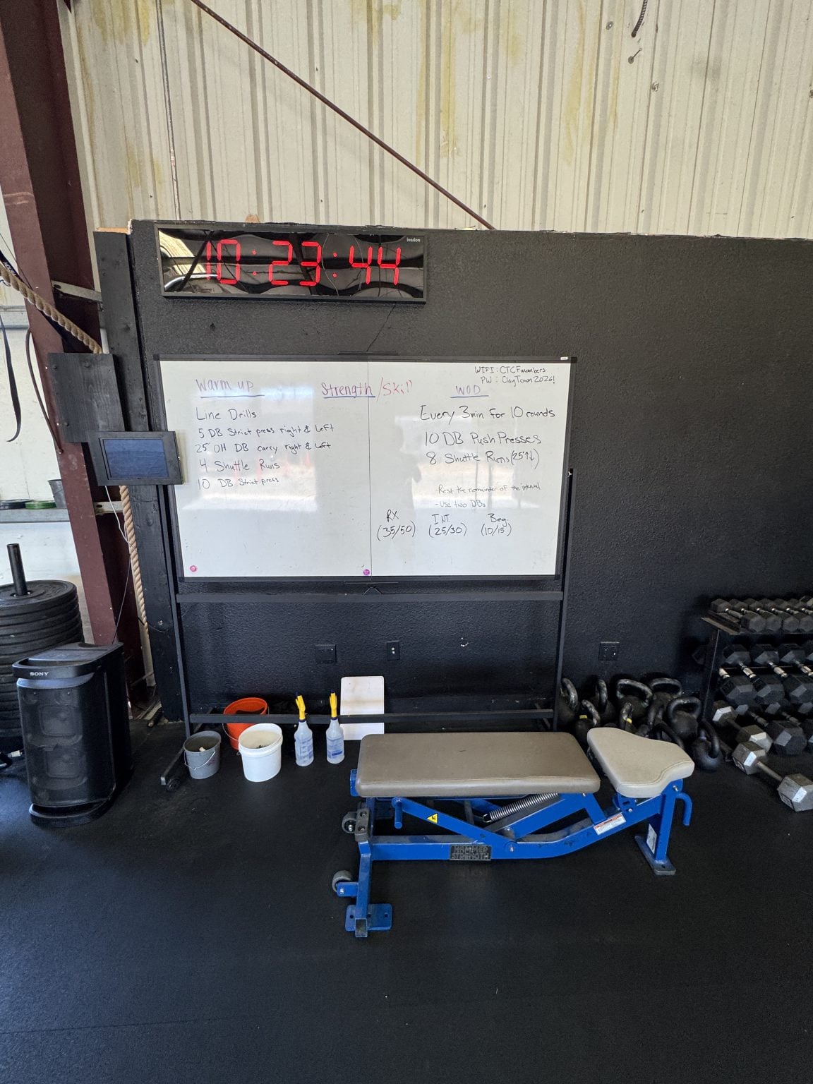 Daily workout whiteboard showing Rx, intermediate, and beginner scaling options
